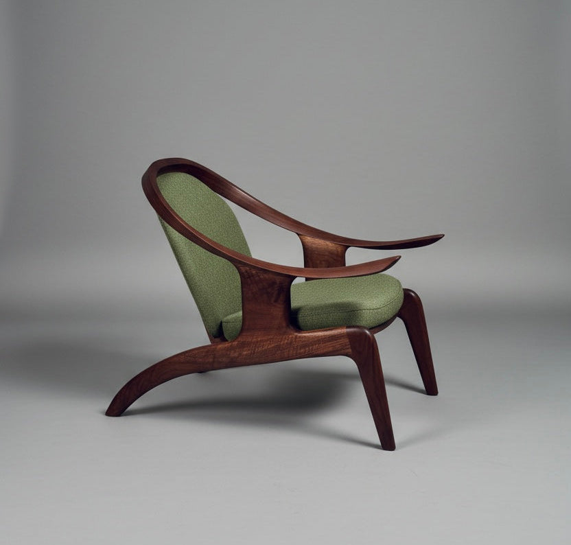 Modern chair with wooden frame and green cushions on a gray background