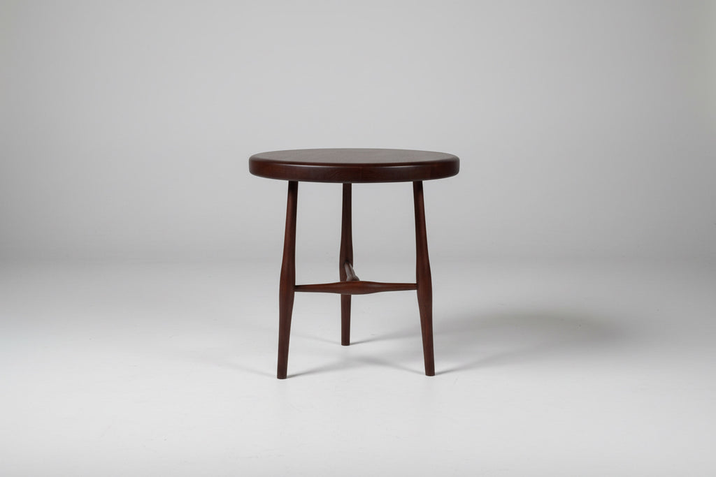 Round wooden stool on a white background
