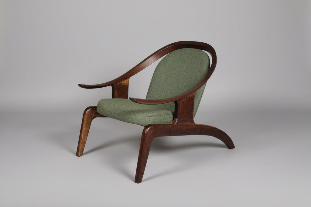 Wooden armchair with green cushion on a gray background