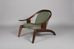Wooden armchair with green cushion on a gray background