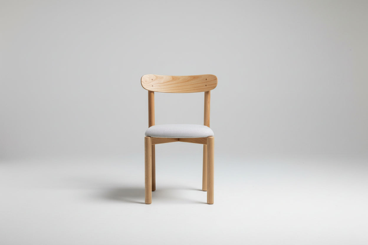 Wooden chair with a white cushion on a gray background