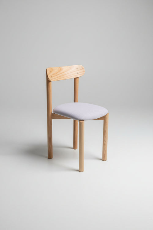 Wooden chair with a white cushion on a gray background