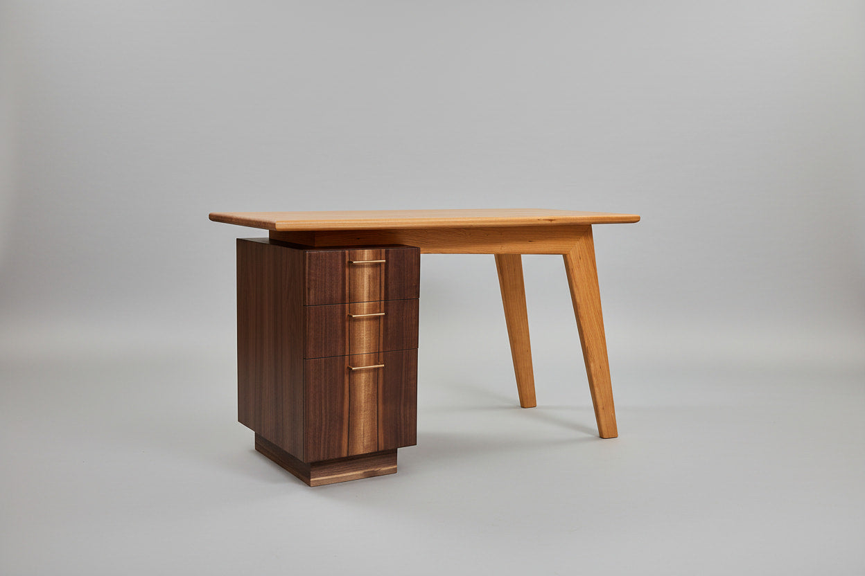 Wooden desk with a cabinet on a gray background