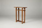 Wooden console table with decorative items against a white wall.